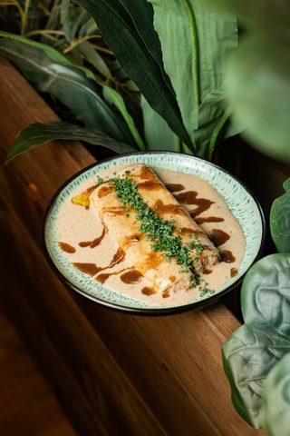 Two cannellons in a creamy sauce with chives