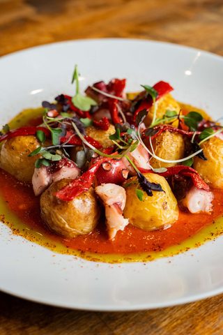 Grilled octopus with potatoes and red pepper strips
